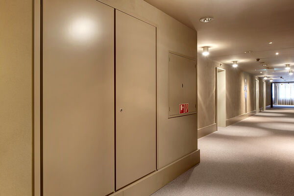 <p><strong>Steigzonen/Elektrofronten</strong><br />Elektroschränke EI30 RF1, farbig gespritzt, in Hotelkorridor.</p>